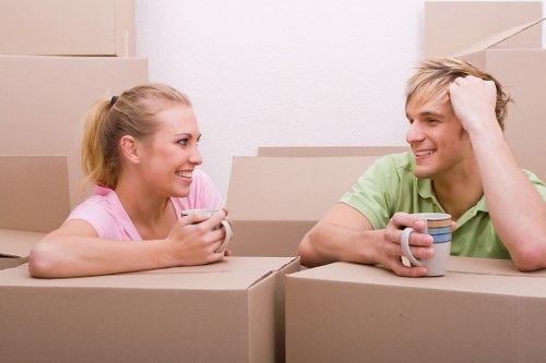 Professional packing team organising moving boxes in a Poplar apartment