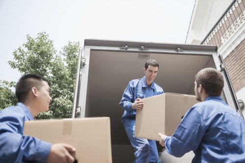Office relocation team handling desks, boxes, and equipment during a Poplar move