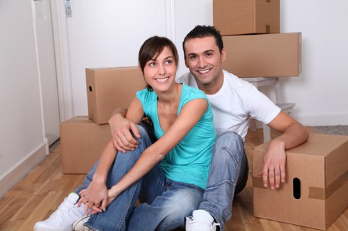 Loading household items into a van for a Poplar move