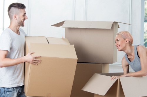 Professional movers loading household items for a Poplar relocation