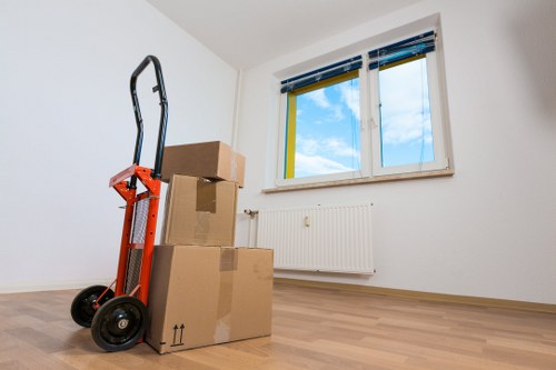 Packed boxes and furniture ready for removals in a Poplar flat